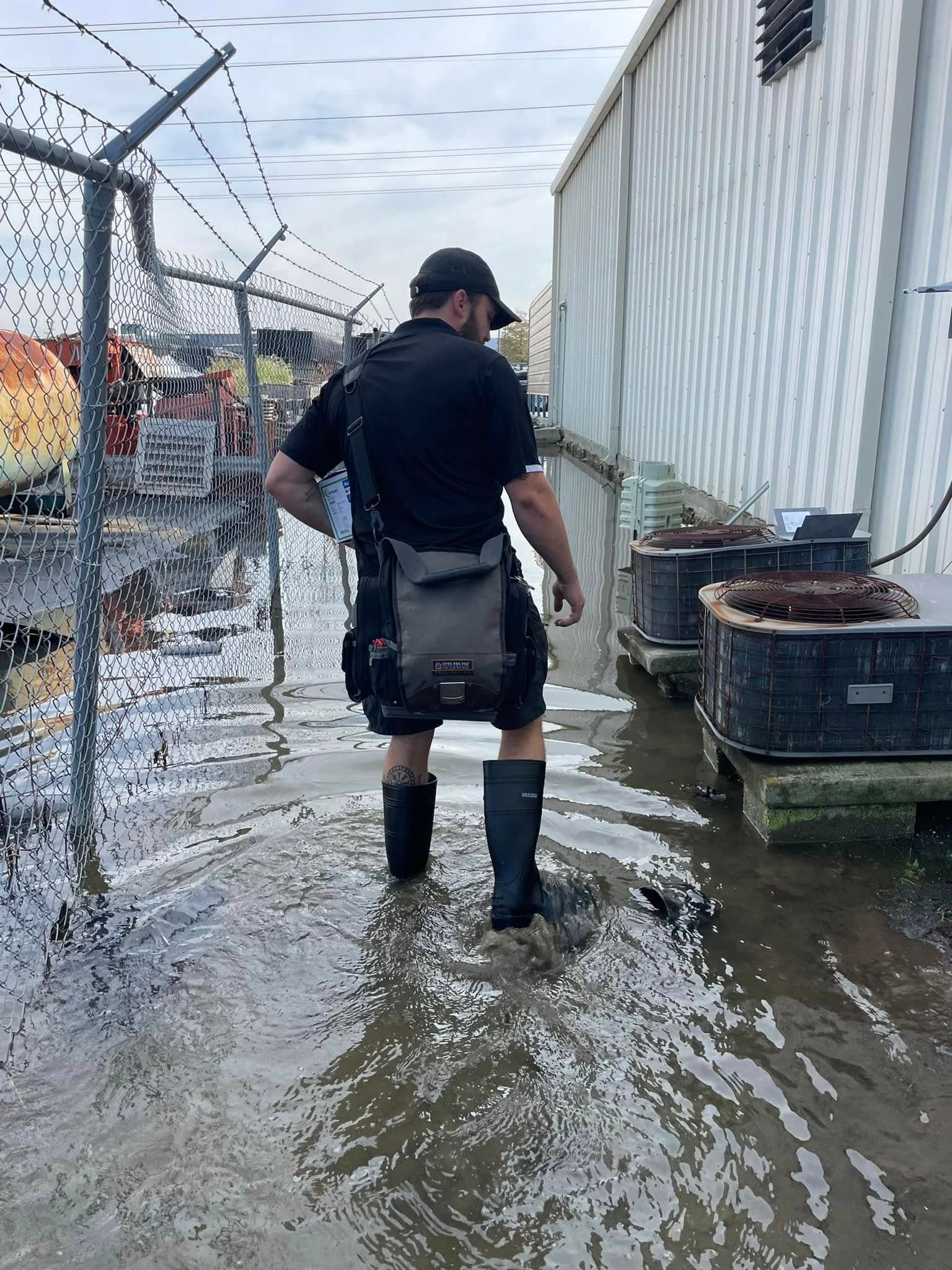 Technician working in flood or water-damaged conditions